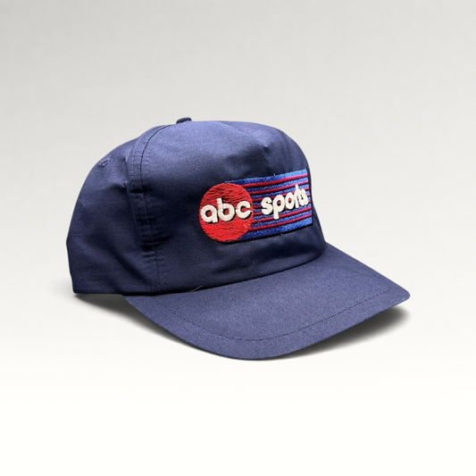 Raree Finds vintage 80s navy blue ABC Sports snapback hat by Wear-Guard with embroidered logo and adjustable closure.