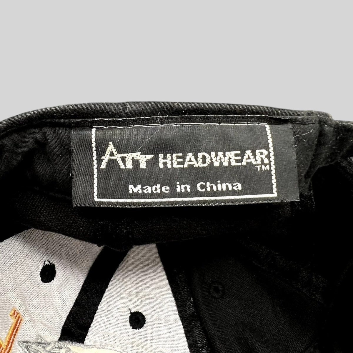 Raree Finds black cotton cap interior showing the Art Headwear brand label and Made in China tag