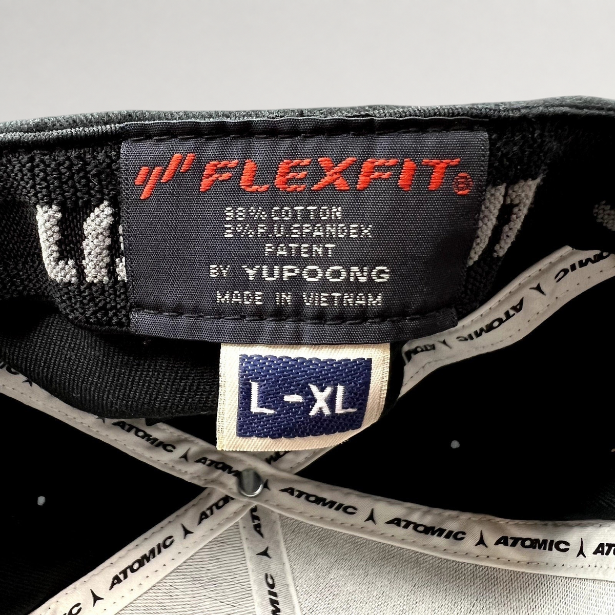 Raree Finds Atomic Skis FlexFit cap interior label showing size L-XL and Yupoong branding