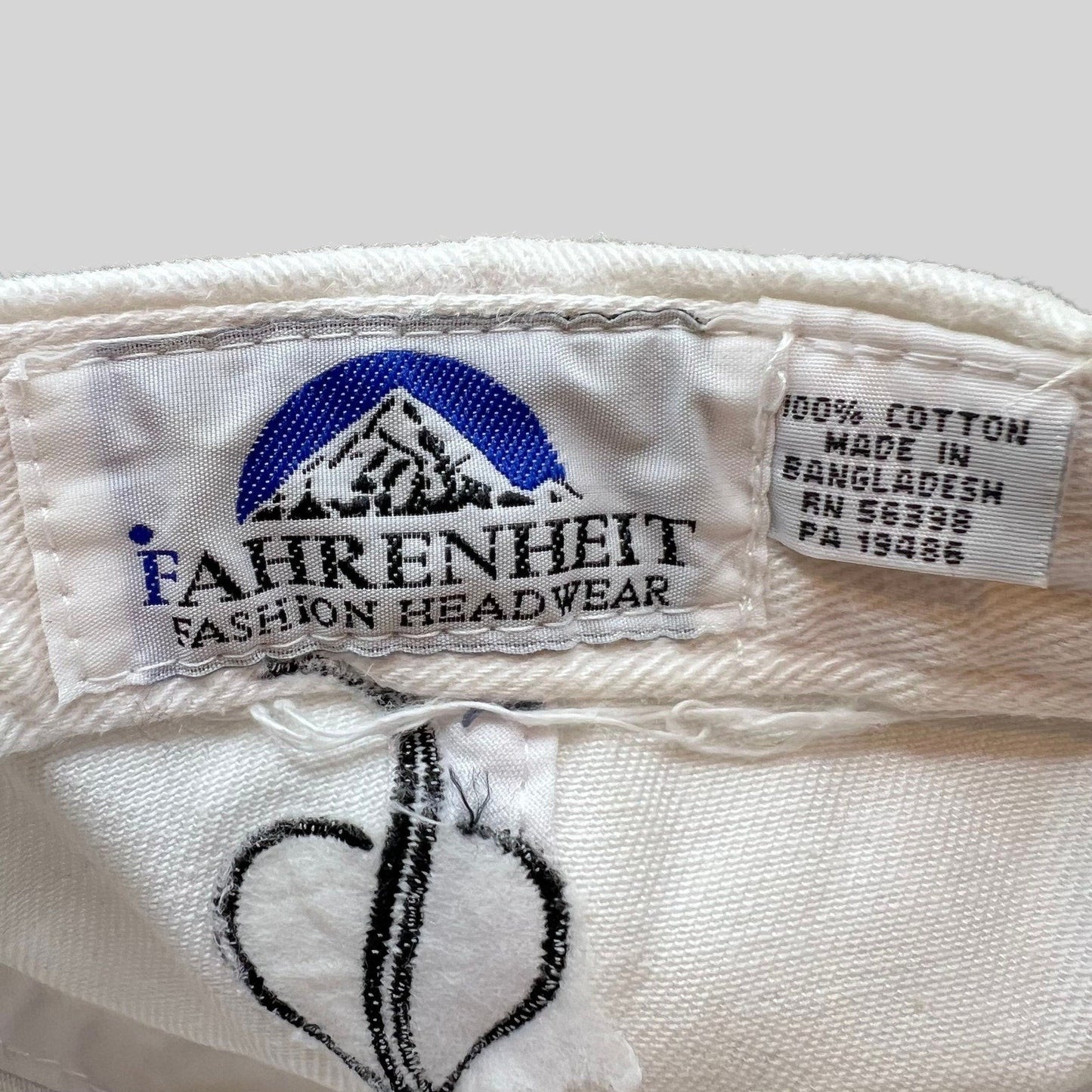 Raree Finds vintage Audi cap interior label showing Fahrenheit Fashion Headwear branding and 100% cotton material tag