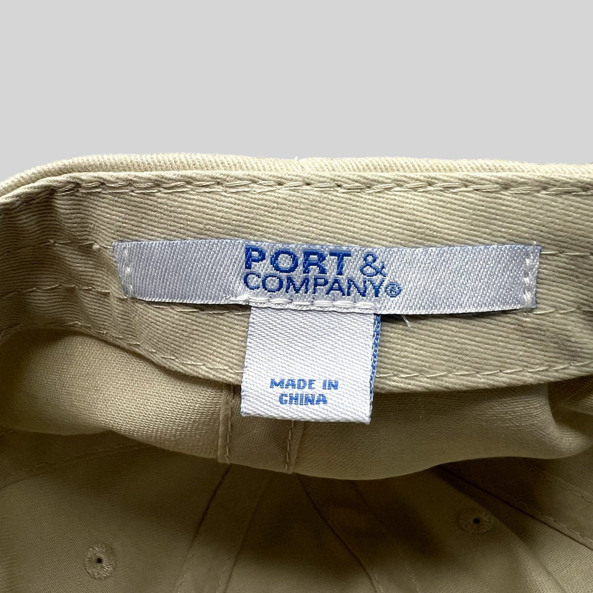 Raree Finds beige cotton strapback hat interior showing Port & Company brand label and Made in China tag