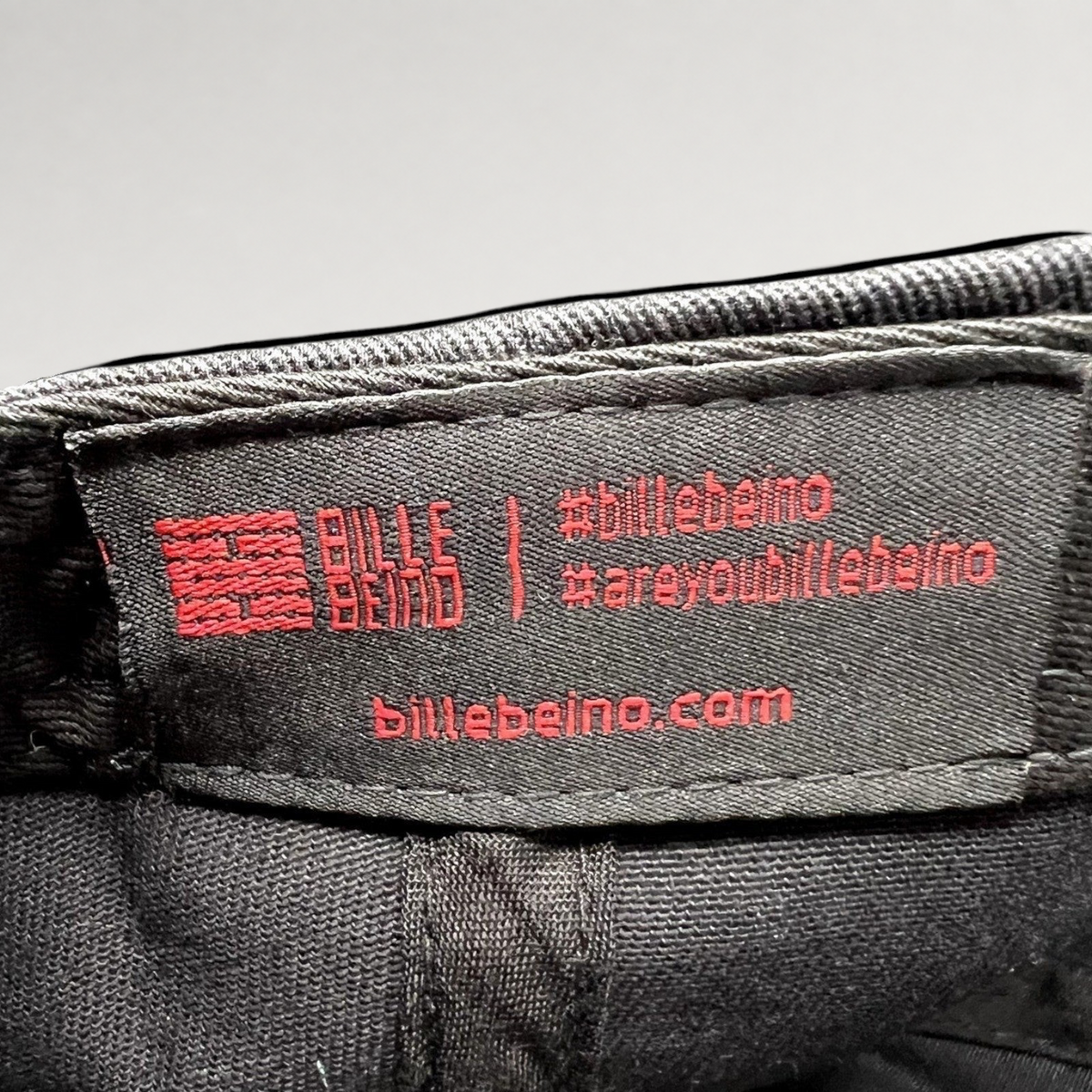 Raree Finds Bille Beino black strapback hat interior fabric label with red embroidered brand logo and website text