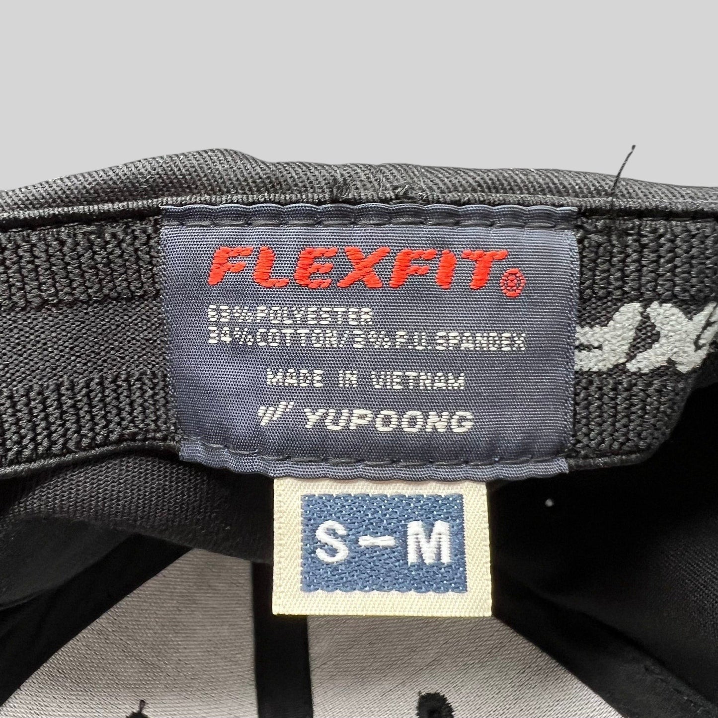 Raree Finds Billions TV show hat interior label showing Yupoong Flexfit branding and size S/M tag