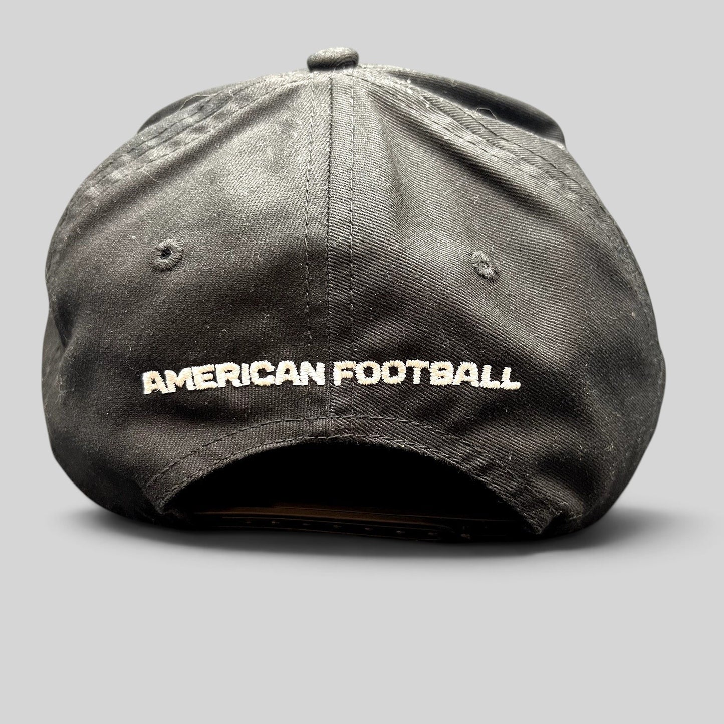 Raree Finds black snapback hat with American Football embroidered in white on the back of the six-panel cap