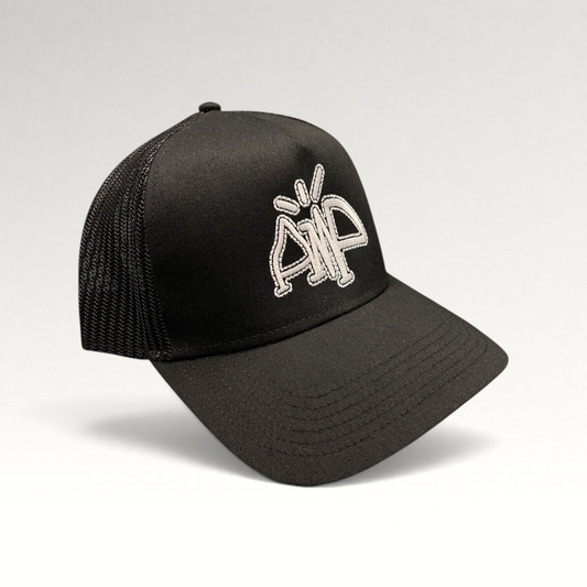 Raree Finds black trucker hat with breathable mesh back and white embroidered AMP logo on the structured front panel.