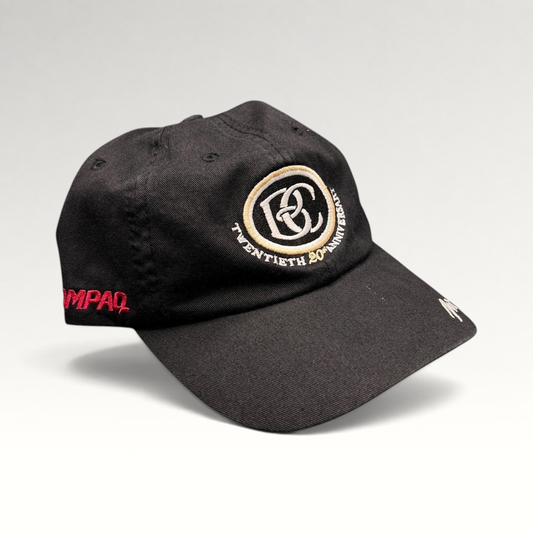Raree Finds black cotton unstructured hat featuring a cream and black BC 20th anniversary logo and side embroidery.