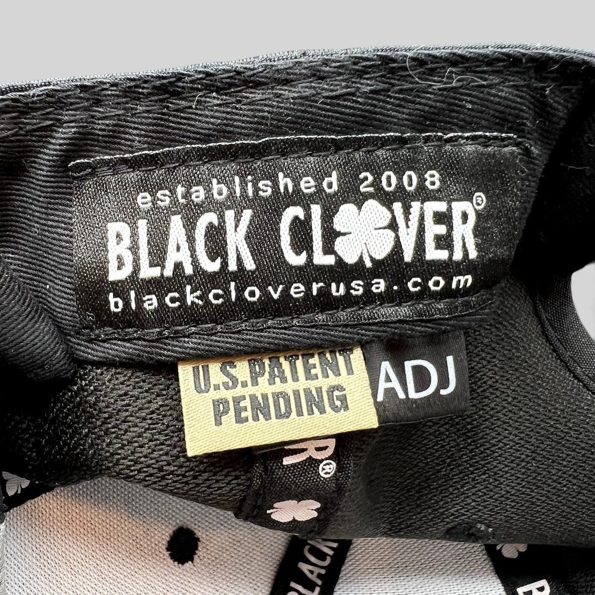 Raree Finds Black Clover hat interior label with U.S. Patent Pending tag and branded taping