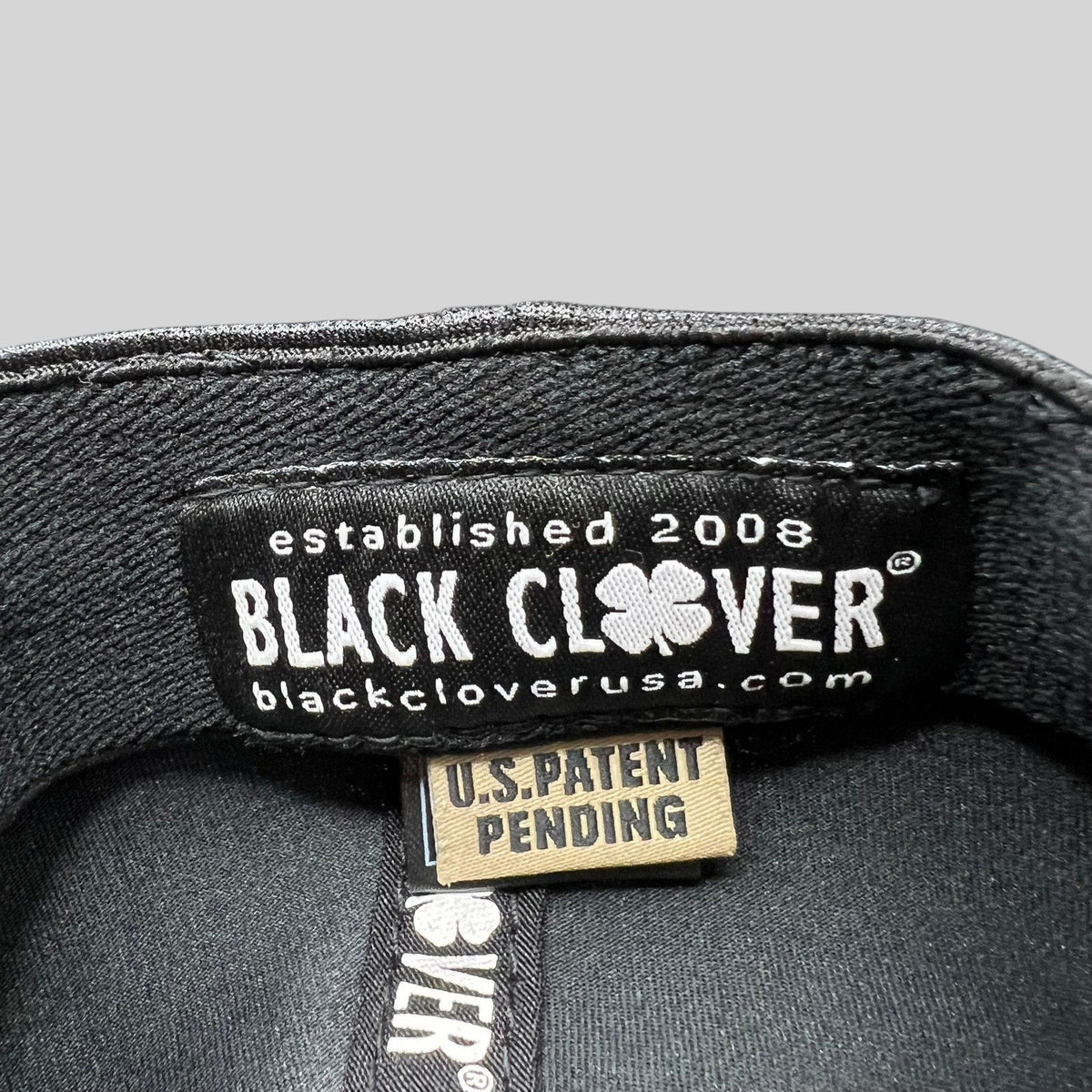 Raree Finds Black Clover Tony Robbins 2026 hat interior label with U.S. Patent Pending tag and branding