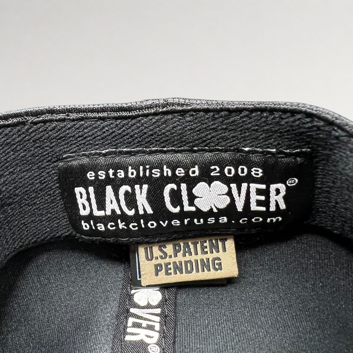 Raree Finds Black Clover Tony Robbins 2026 hat interior label with U.S. Patent Pending tag and branding
