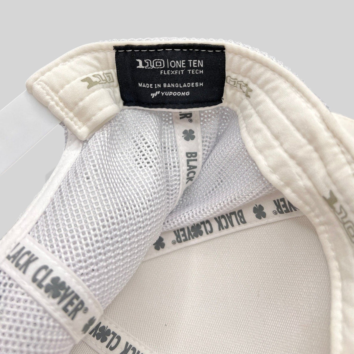 Raree Finds Black Clover Yupoong One Ten Flexfit white trucker hat interior label and branded seam tape detail