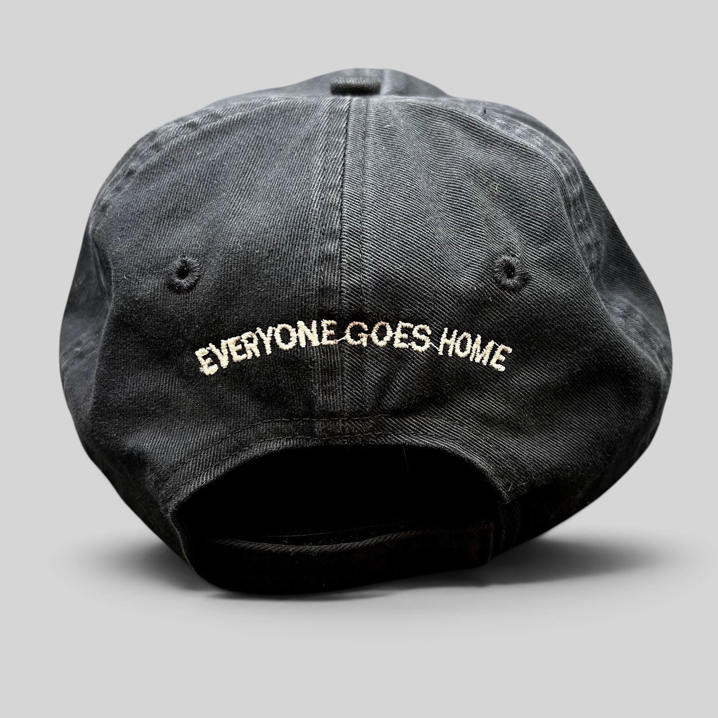 Raree Finds black cotton strapback hat with Everyone Goes Home embroidered on the back in white thread