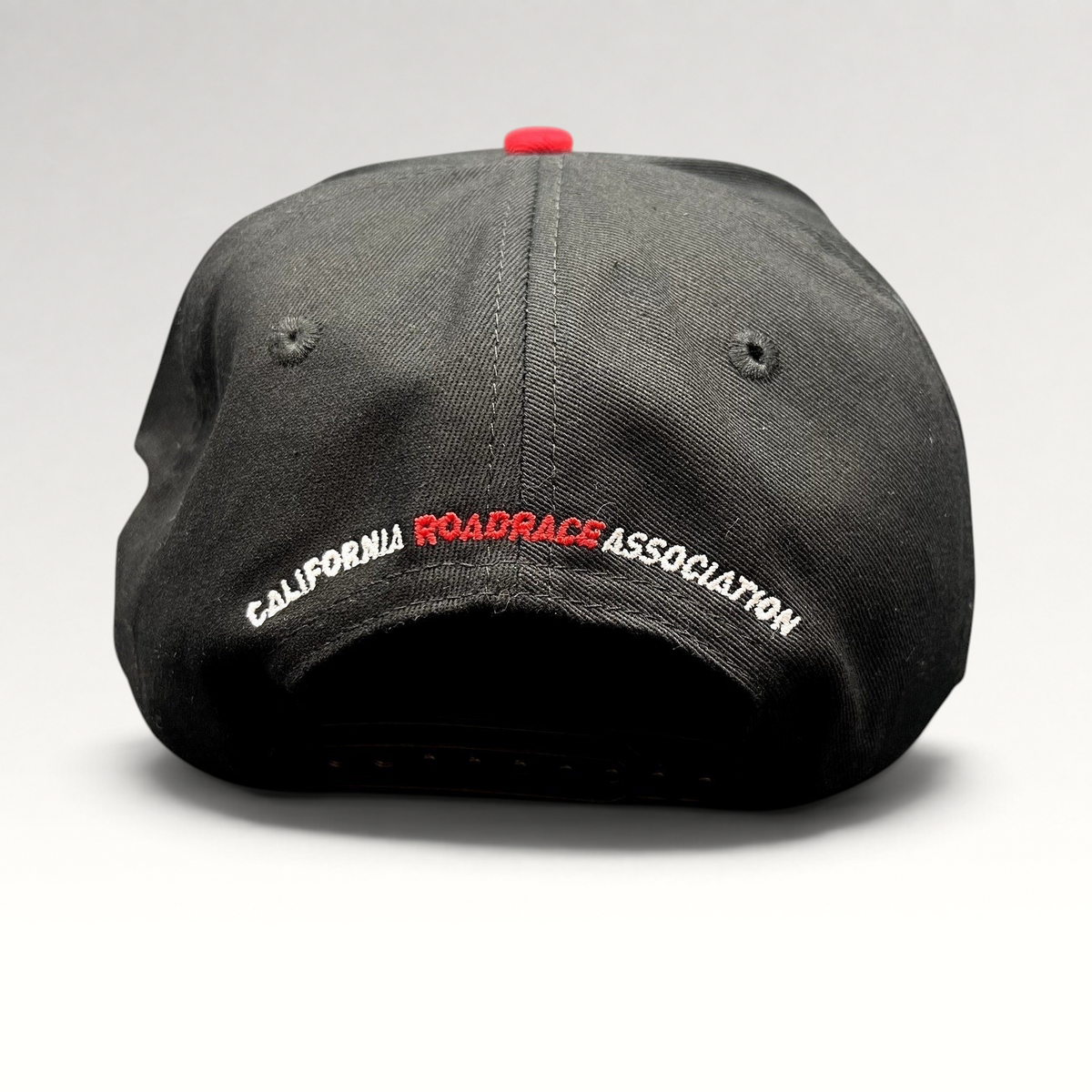 Raree Finds black snapback hat with California RoadRace Association embroidery on the back and a red top button