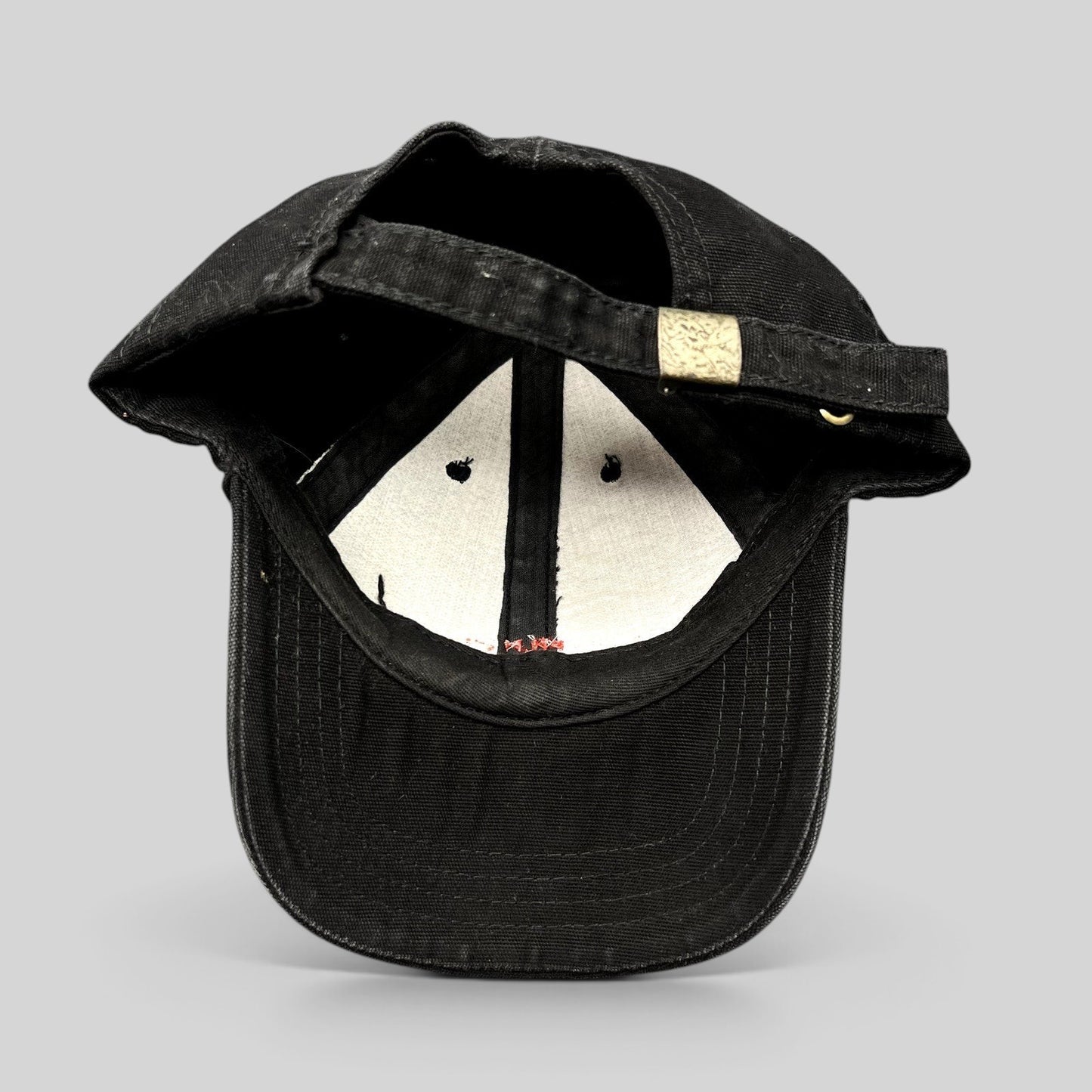 Raree Finds black Colorado Film Commission strapback hat showing the adjustable metal slider buckle and interior lining