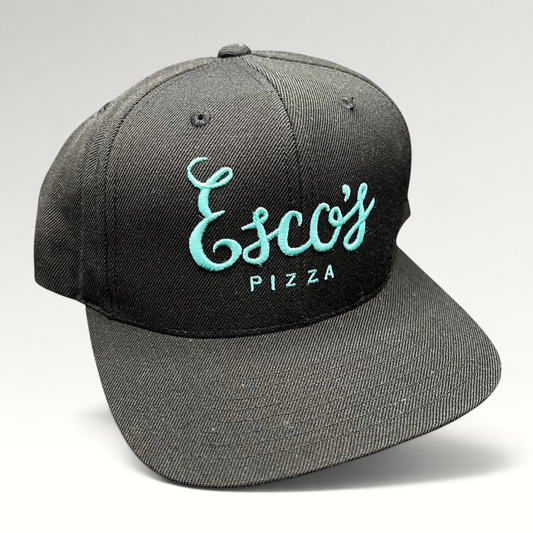 Raree Finds black snapback hat with teal Esco’s Pizza script embroidery on the front and a flat brim.