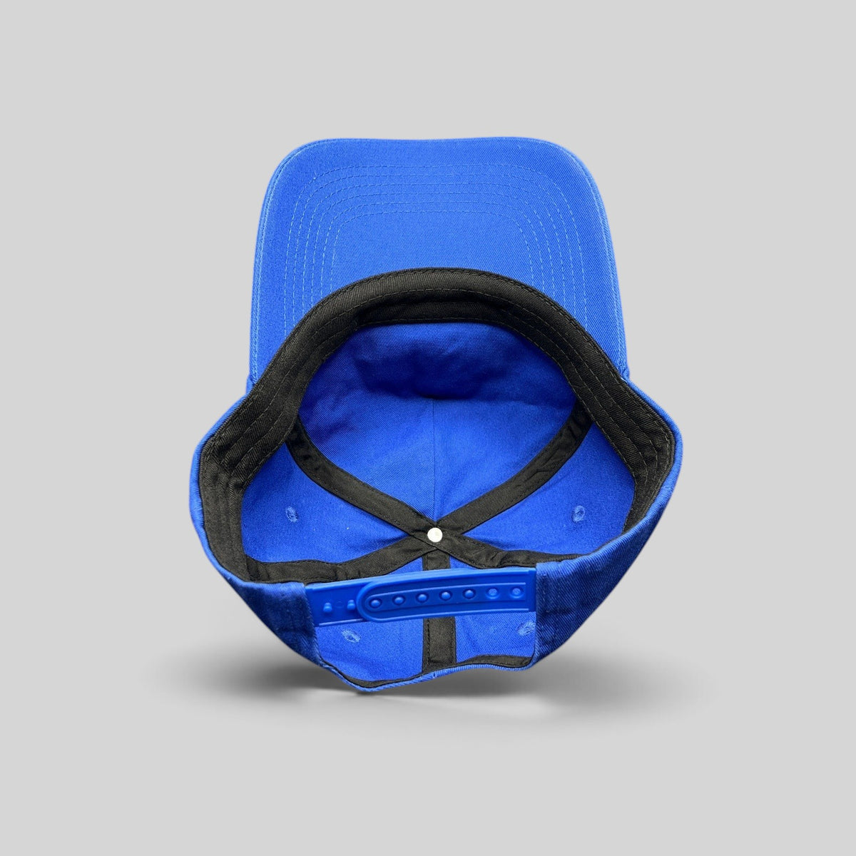 Raree Finds vintage royal blue snapback hat interior view showing adjustable plastic strap and structured crown