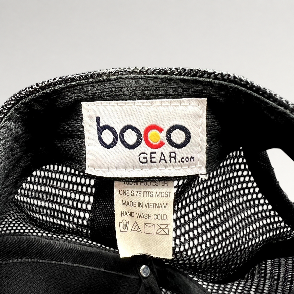 Raree Finds Boco Gear trucker hat interior tag showing brand logo, material composition, and care instructions.