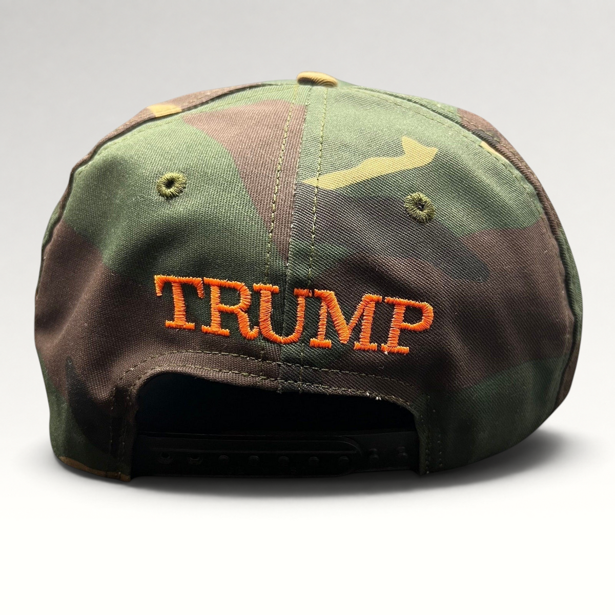 Raree Finds woodland camo snapback hat with orange TRUMP embroidery on the back and a black plastic snap closure.