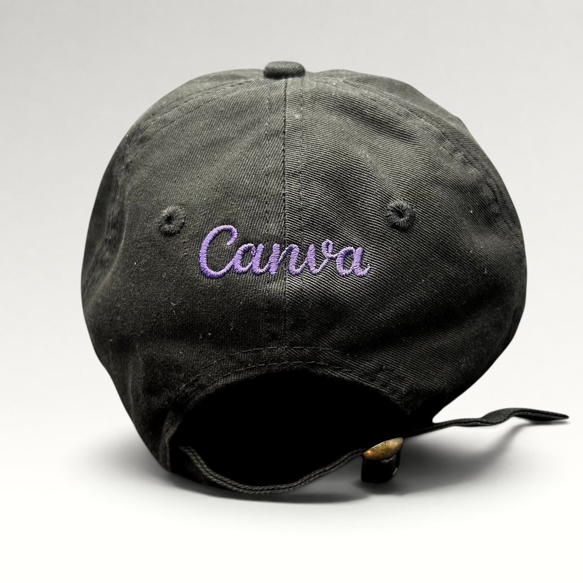 Raree Finds black cotton dad hat with purple embroidered Canva logo on the back and adjustable brass buckle strap