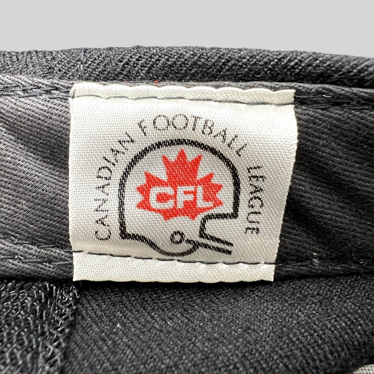 Raree Finds vintage Birmingham Barracudas CFL hat interior tag with Canadian Football League logo and helmet graphic