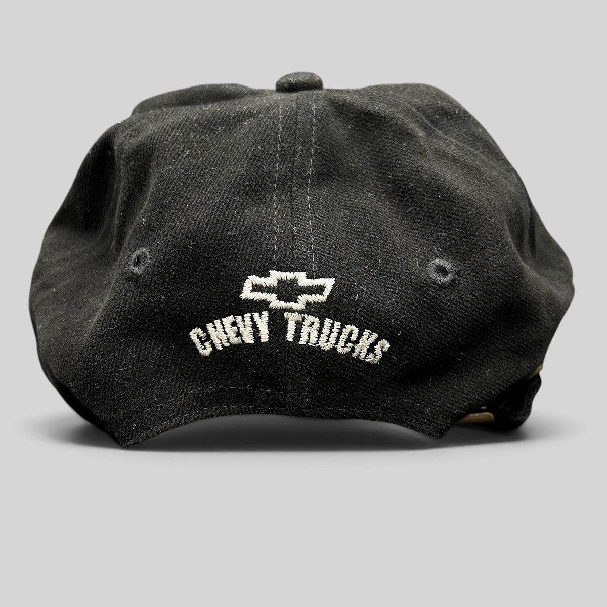 Raree Finds vintage black cotton strapback hat featuring white embroidered Chevy Trucks logo on the back panel.