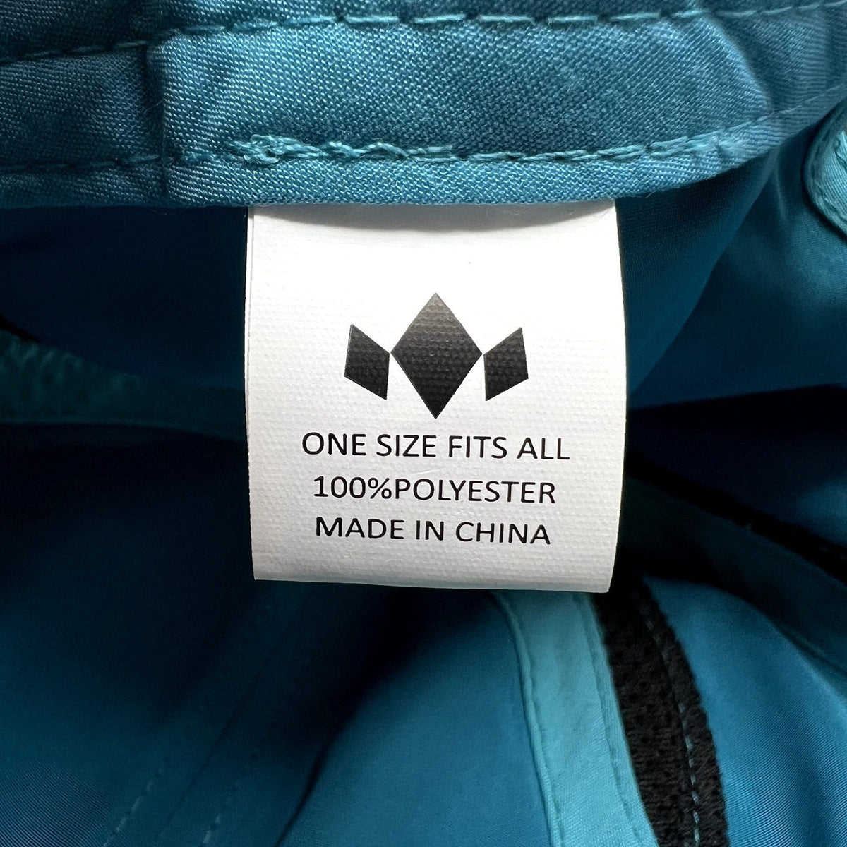 Raree Finds Diadem performance hat interior label showing 100 percent polyester material and one size fits all sizing