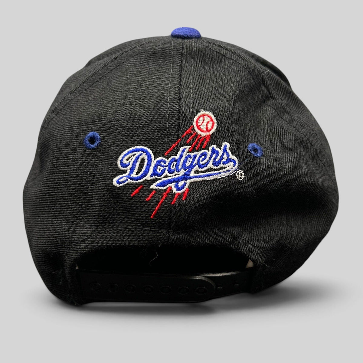 Raree Finds vintage 90s Los Angeles Dodgers snapback hat with embroidered team logo and baseball trail on the back