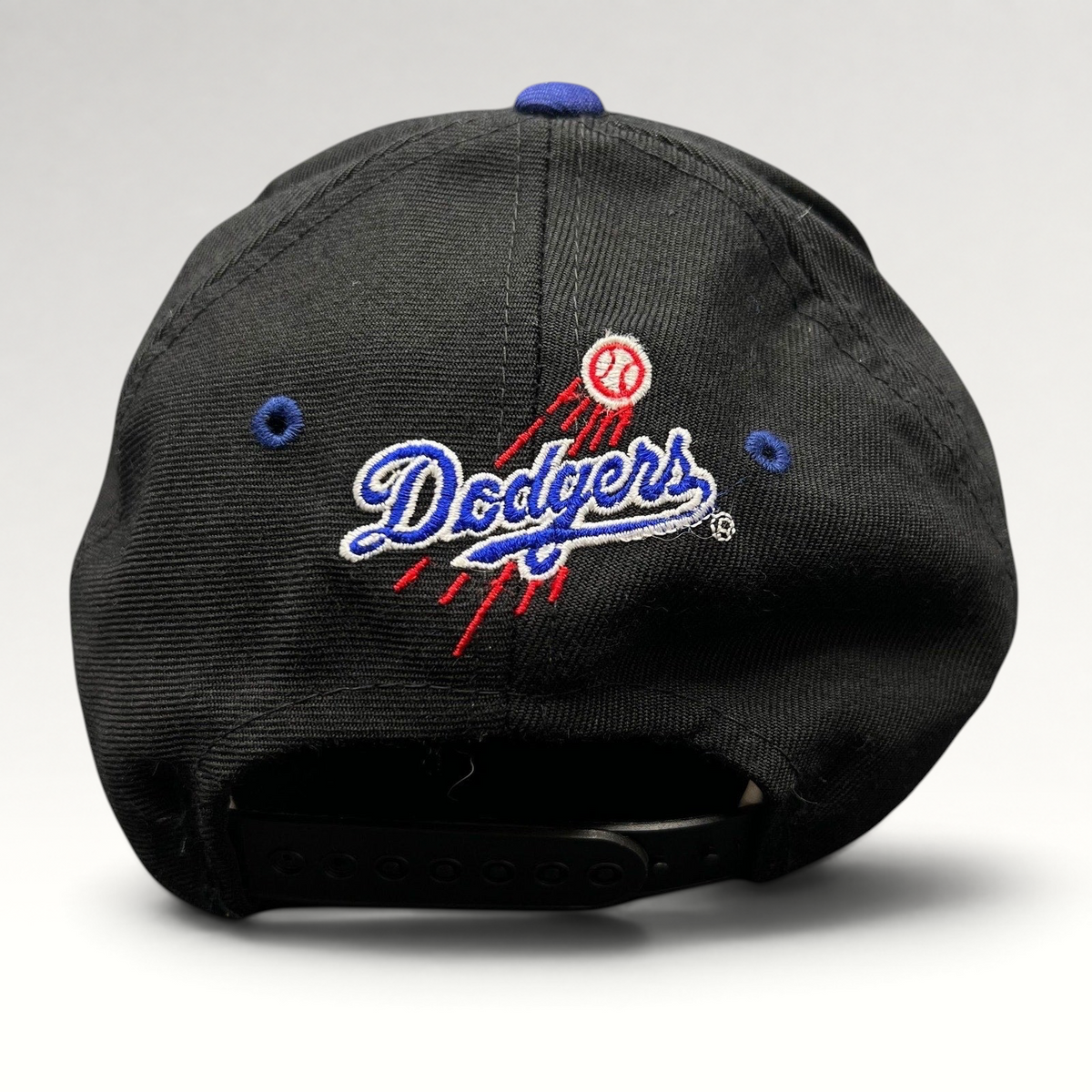 Raree Finds vintage 90s Los Angeles Dodgers snapback hat with embroidered team logo and baseball trail on the back