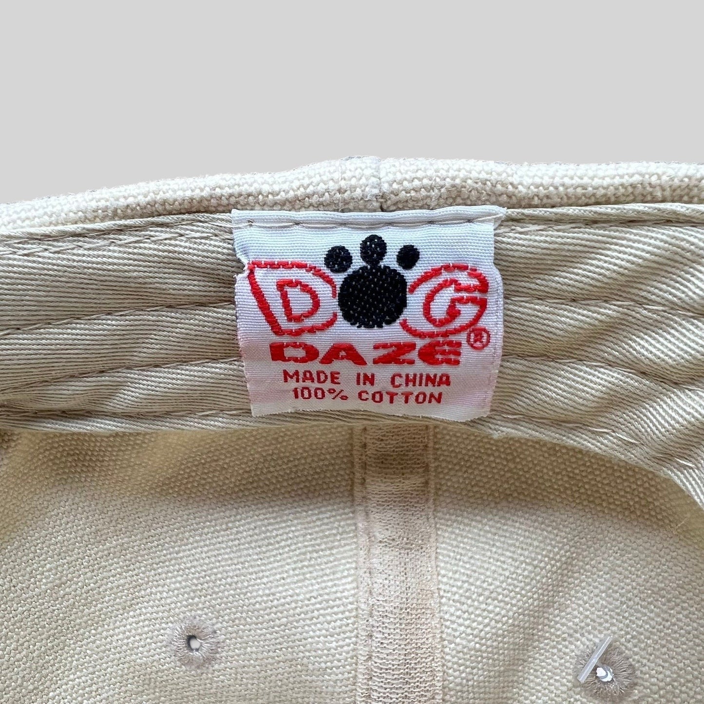 Raree Finds vintage Dog Daze brand tag inside an off-white cotton canvas strapback cap