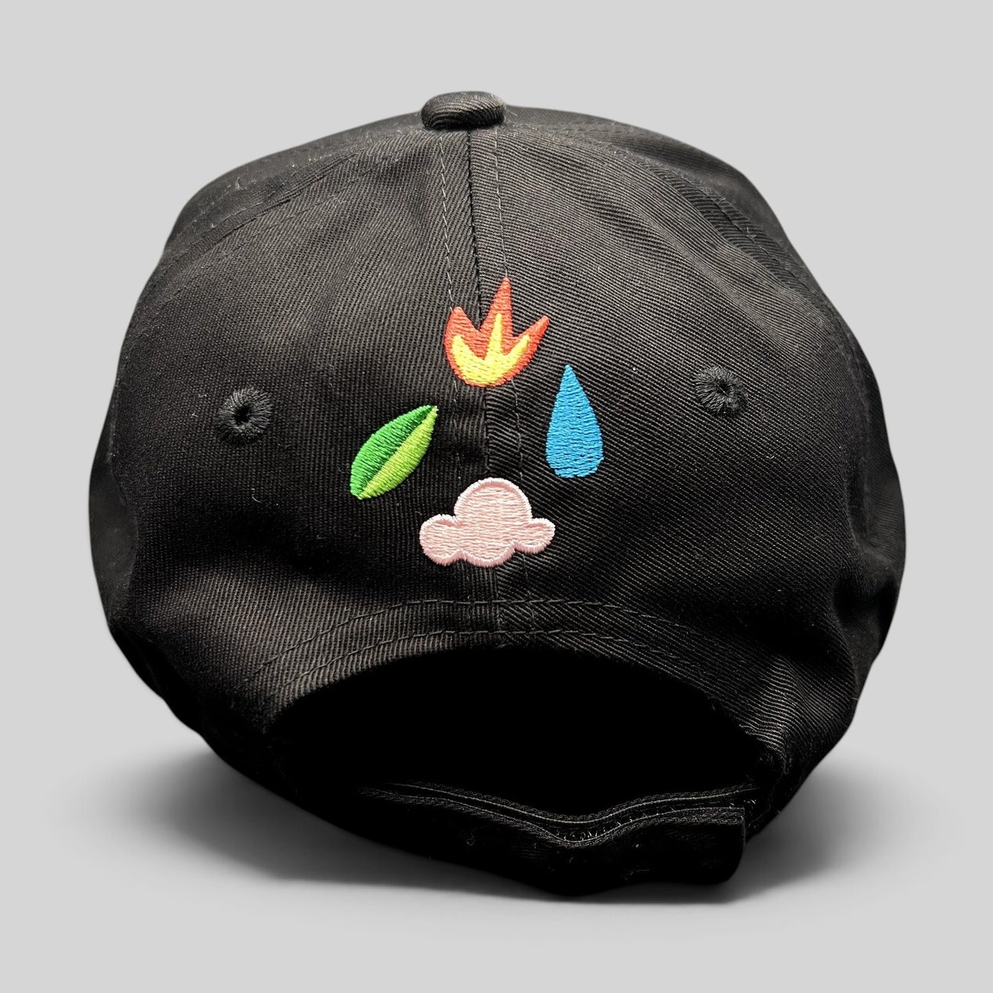 Raree Finds black strapback hat featuring colorful elemental icon embroidery on the back panel