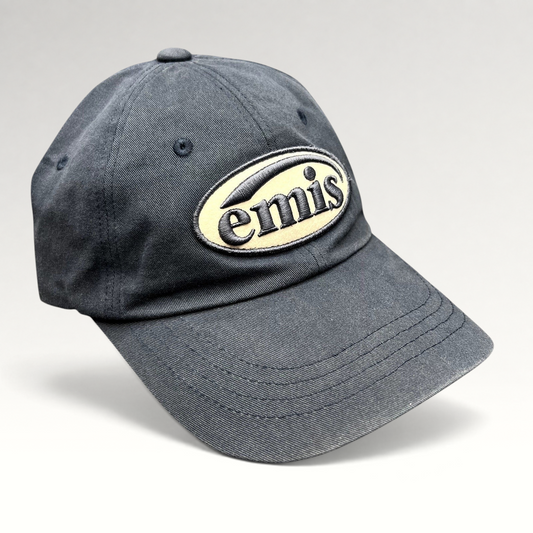 Raree Finds navy EMIS strapback hat with a cream oval logo embroidery on the front and a curved brim.