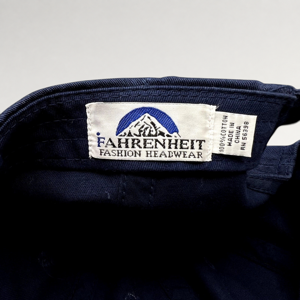 Raree Finds vintage Fahrenheit Fashion Headwear label inside a navy blue cotton golf hat