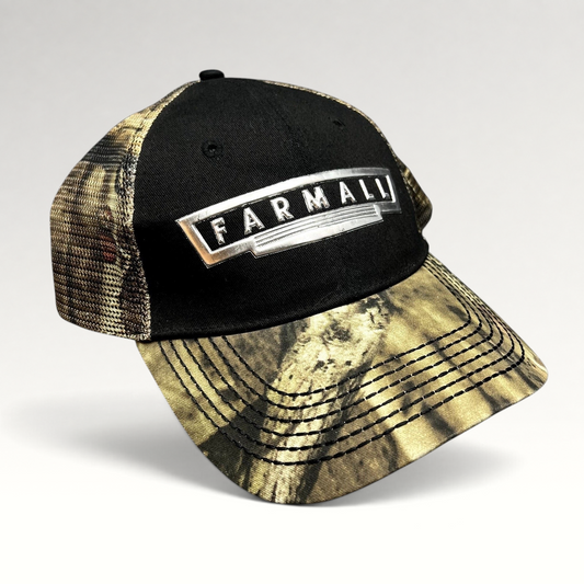 Raree Finds Farmall trucker hat with black cotton crown, camouflage mesh back, and metallic logo patch on curved brim