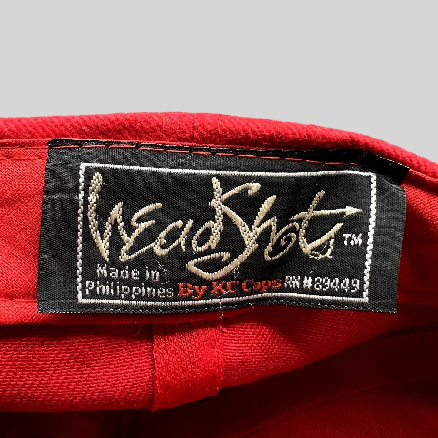 Raree Finds vintage Headshots by KC Caps label inside a bright red promotional hat made in the Philippines