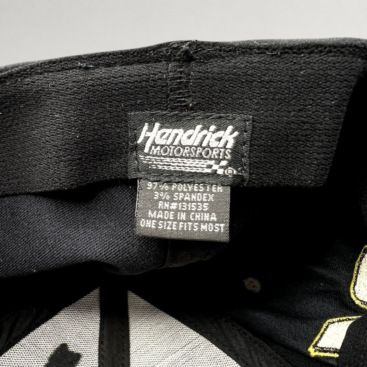 Raree Finds Hendrick Motorsports hat interior tag showing polyester and spandex material composition