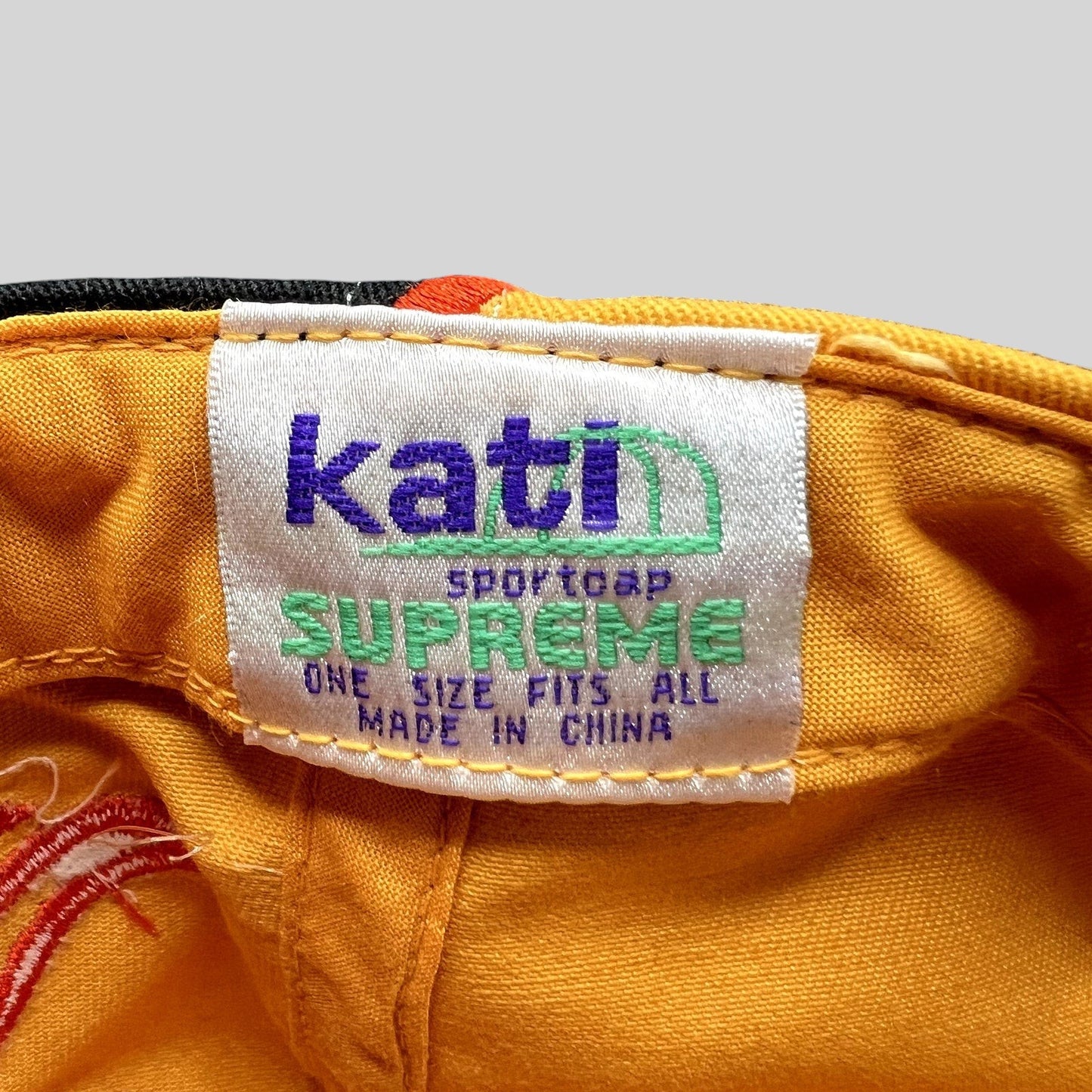 Raree Finds vintage Kati Sportcap Supreme hat interior label with yellow cotton fabric and embroidered flame detail