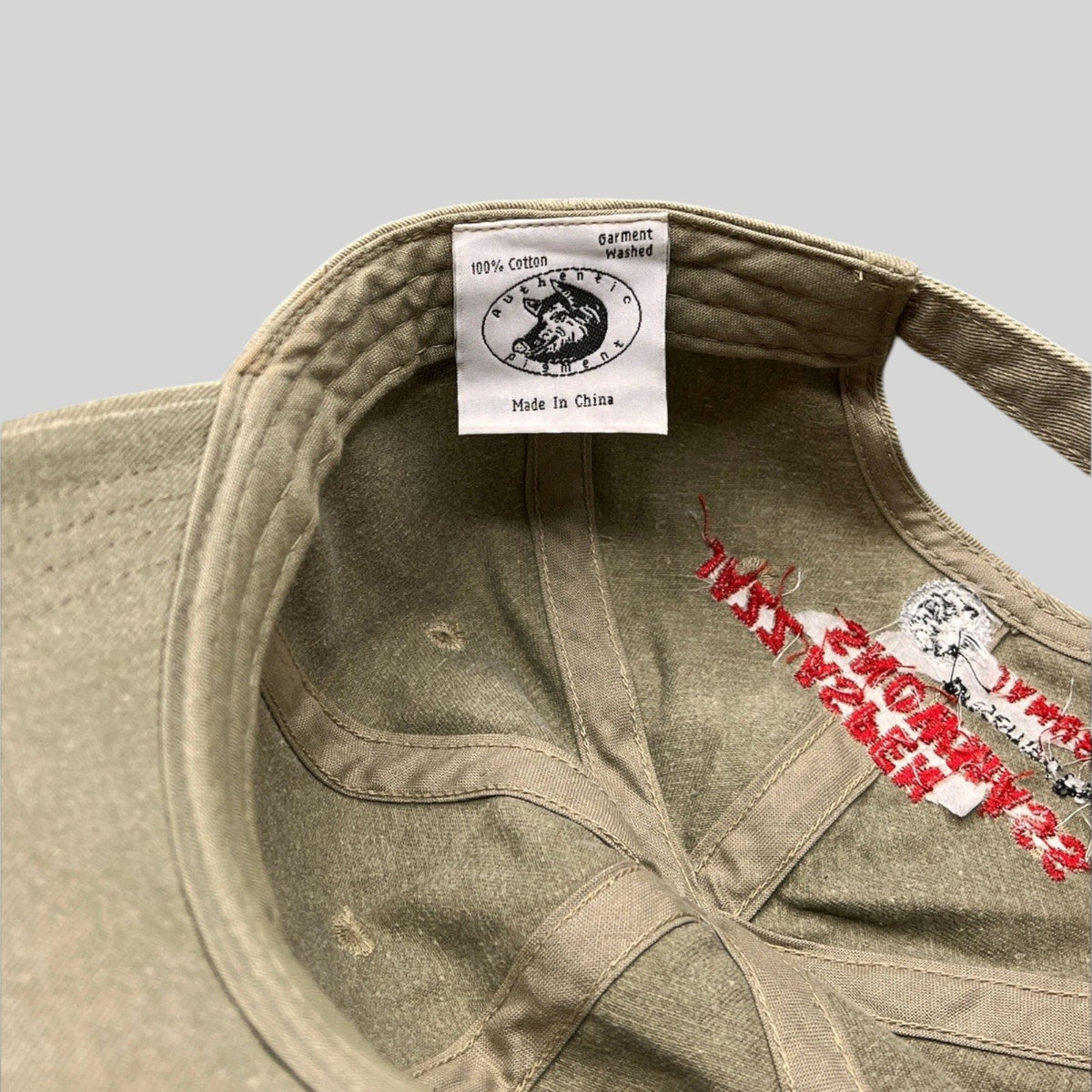 Raree Finds khaki cotton dad hat interior showing festival branding and garment washed label