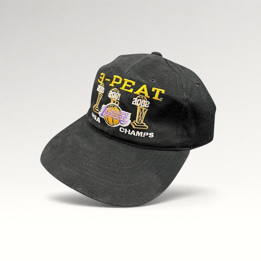 Raree Finds vintage black cotton Los Angeles Lakers 3-Peat NBA championship hat with gold and purple embroidery.