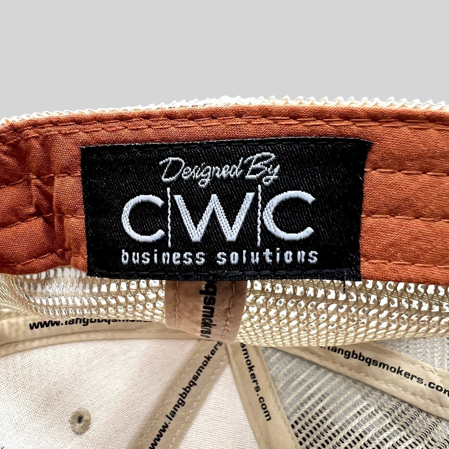 Raree Finds Lang BBQ Smokers trucker hat interior featuring a CWC Business Solutions branded tag and mesh lining