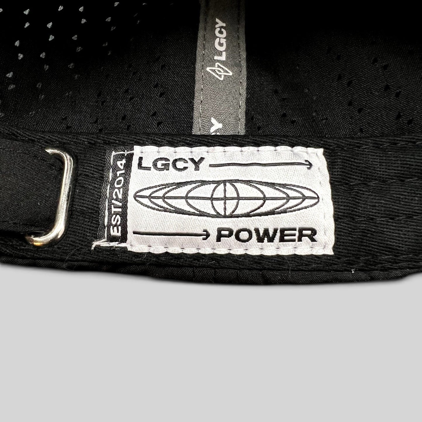 Raree Finds LGCY black performance hat featuring a white woven brand label on the adjustable strapback closure.
