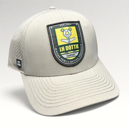 Raree Finds LH Dottie Company tan snapback hat with embroidered shield patch and perforated side panels