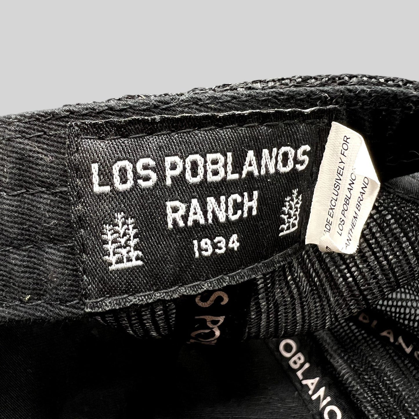 Raree Finds Los Poblanos Ranch 1934 black trucker hat interior label with branding and mesh panel detail