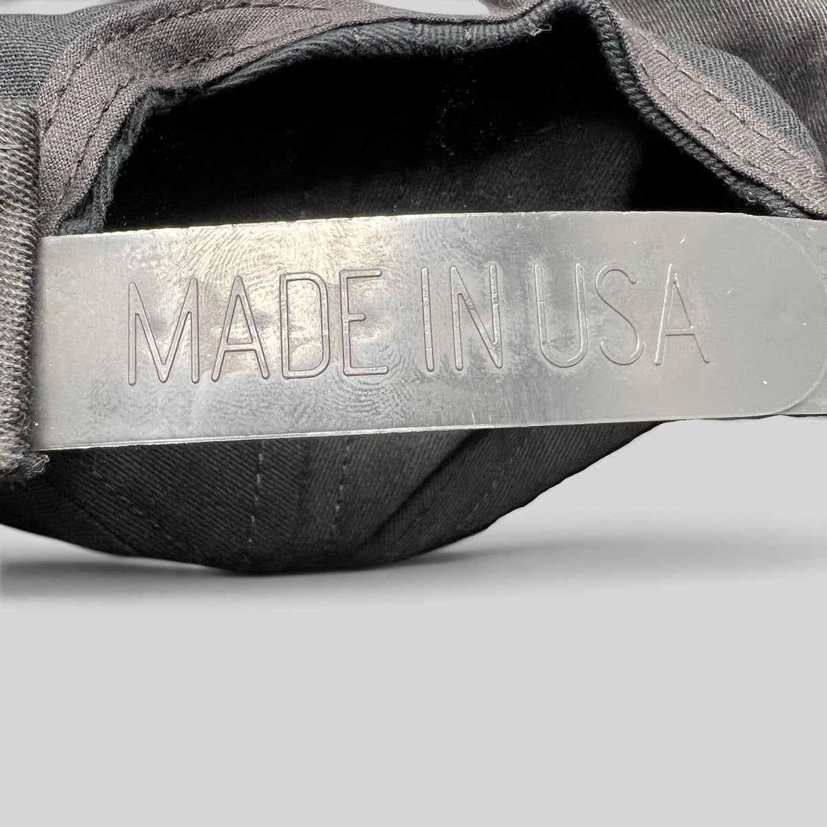 Raree Finds vintage Competition Headwear snapback hat showing the Made in USA stamp on the plastic adjustable strap.