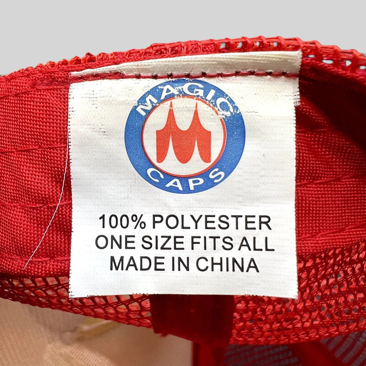 Raree Finds vintage Magic Caps trucker hat interior tag showing polyester material and one size fits all details
