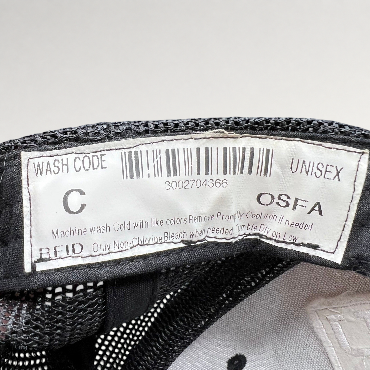 Raree Finds Marvel Damage Control trucker hat interior care label with barcode and OSFA sizing information