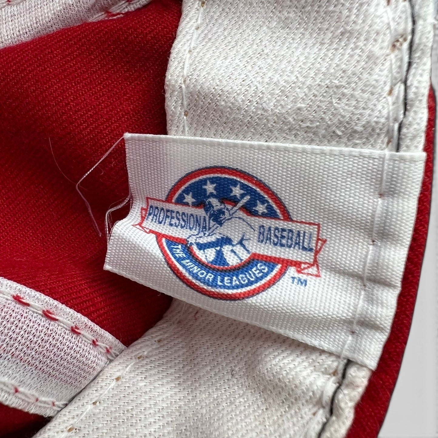 Raree Finds vintage Minor League Baseball tag on a red New Era Chattanooga Lookouts snapback hat interior