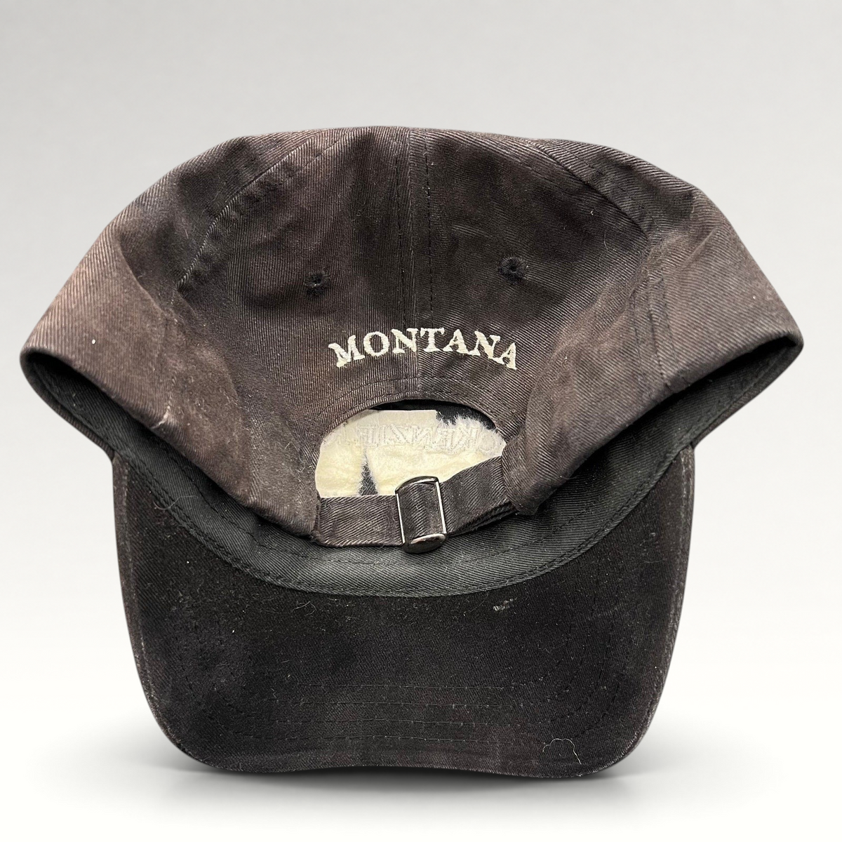 Raree Finds vintage dark brown strapback hat with Montana embroidered on the back in white thread