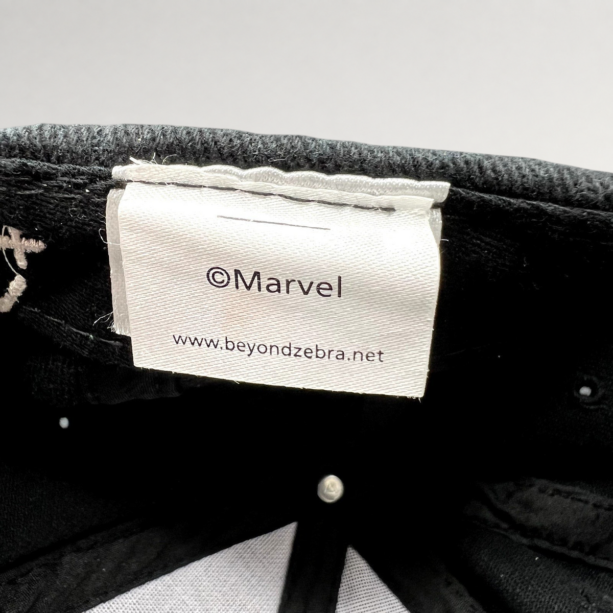 Raree Finds Moon Knight crew hat interior label featuring Marvel and Beyond Zebra branding on a black cotton cap