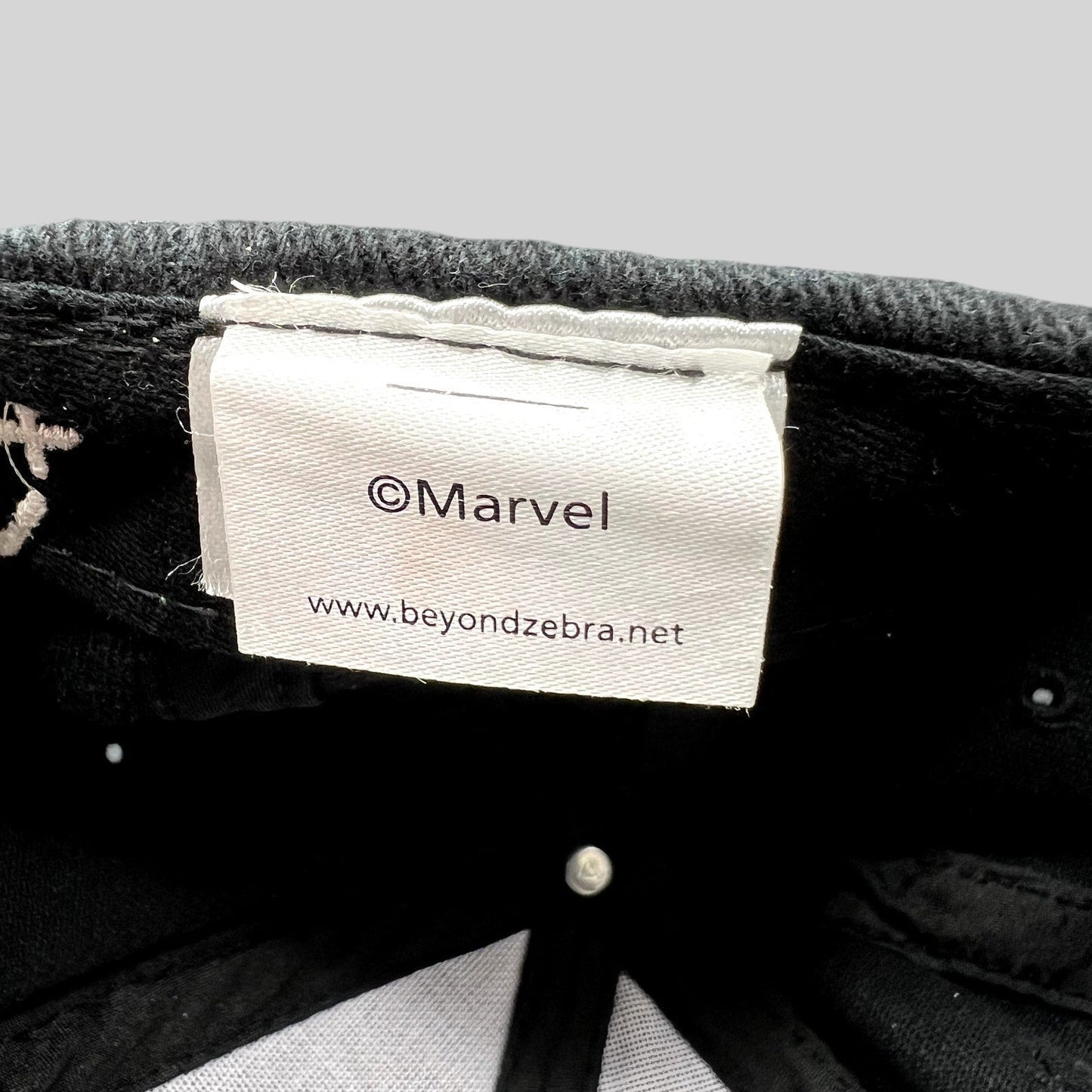 Raree Finds Moon Knight cast and crew hat interior tag with Marvel and Beyond Zebra branding on black cotton fabric