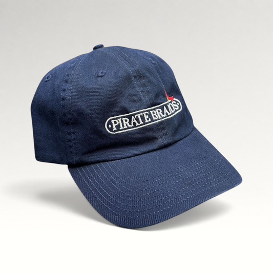Raree Finds navy cotton dad hat with embroidered Pirate Brands logo and red parrot detail on a curved brim cap.