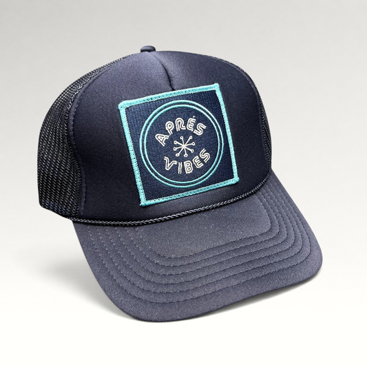 Raree Finds navy blue trucker hat with an Après Vibes embroidered patch, mesh back, and adjustable snapback closure.